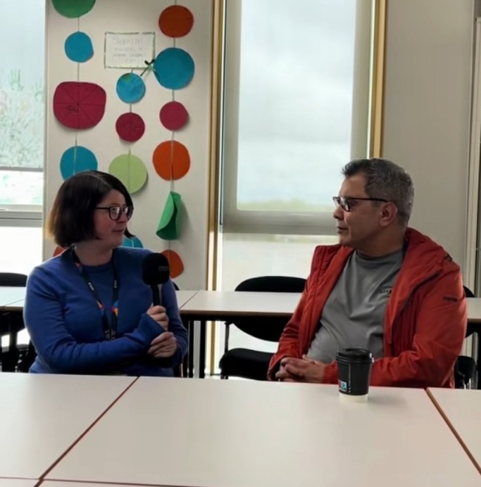 Higher ESOL tutor interviewing an ESOL student in a classroom about his learning experience and future goals at Glasgow Kelvin College.