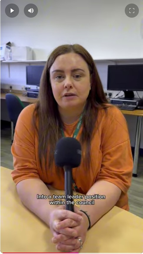 Childcare student at Glasgow Kelvin College speaking on camera about her career progression, seated in a computer classroom.